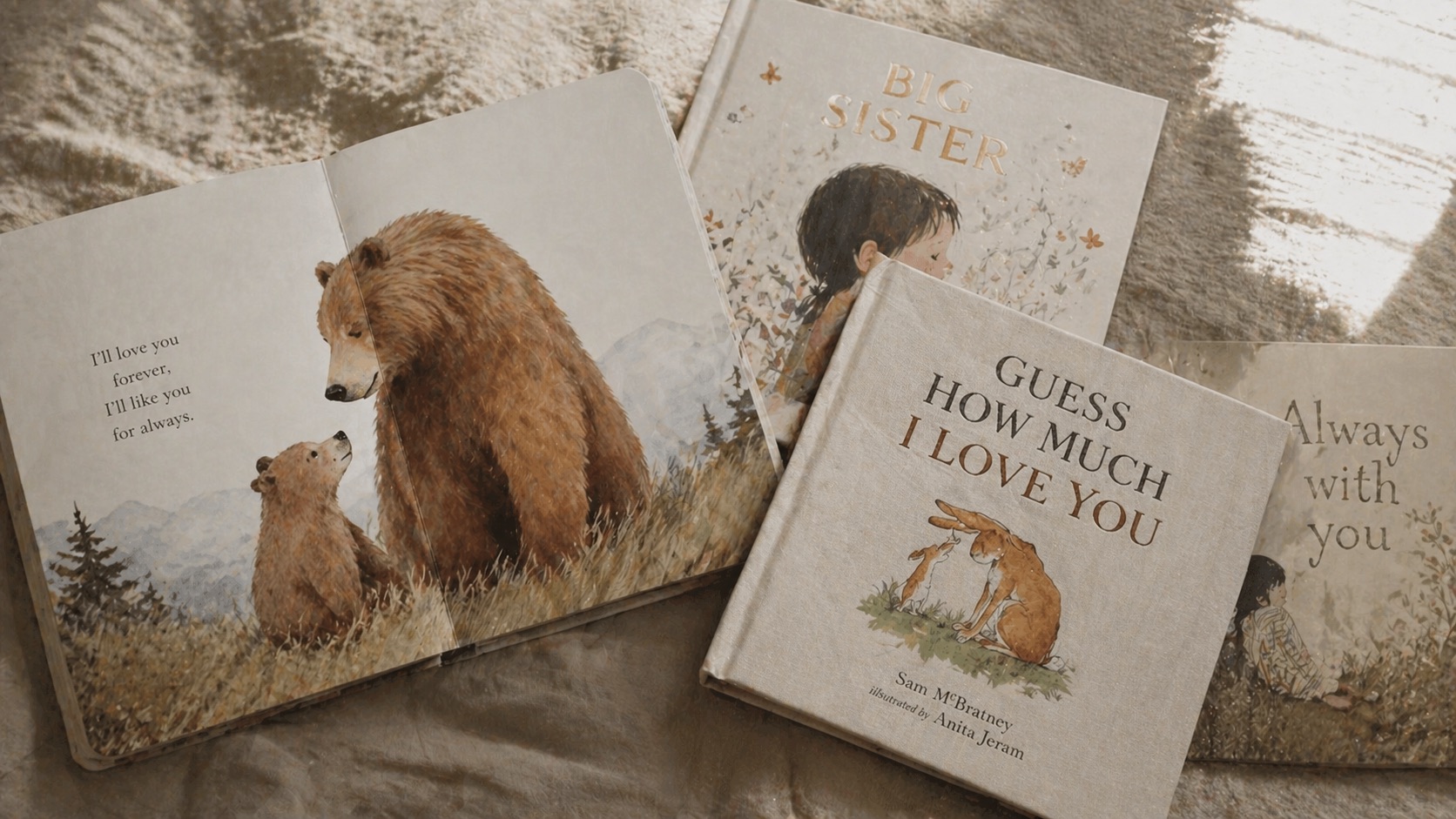 Four well-loved children's picture books arranged on soft linen in warm natural light.
