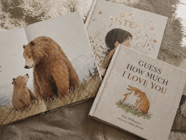 Four well-loved children's picture books on linen.
