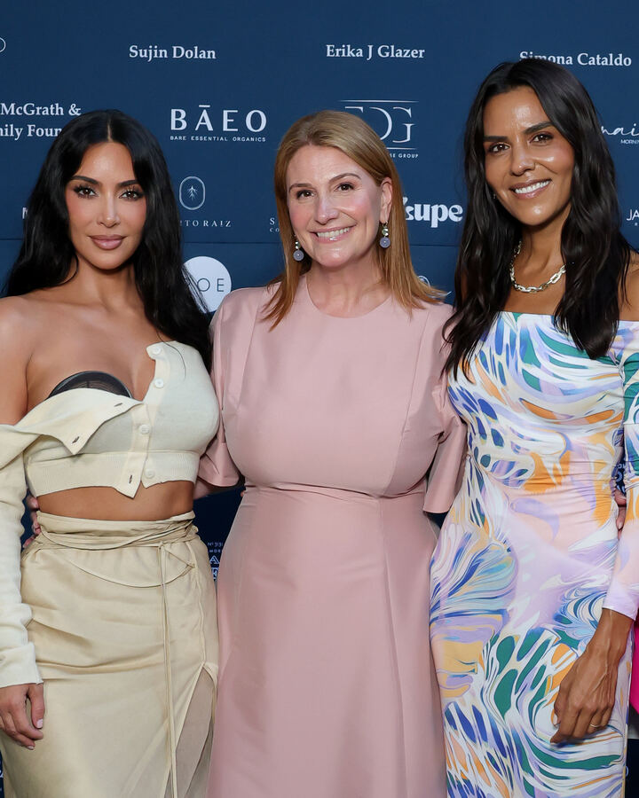 Kim Kardashian in cream, Zoe Winkler Reinis in a blush dress and Elsa Marie Collins in a pastel printed dress at the This Is About Humanity Soirée step-and-repeat.