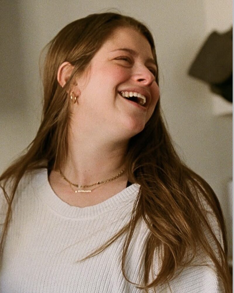Rachel Kornblum, the children's musician known as Rockin' Rach, laughing in her kitchen.