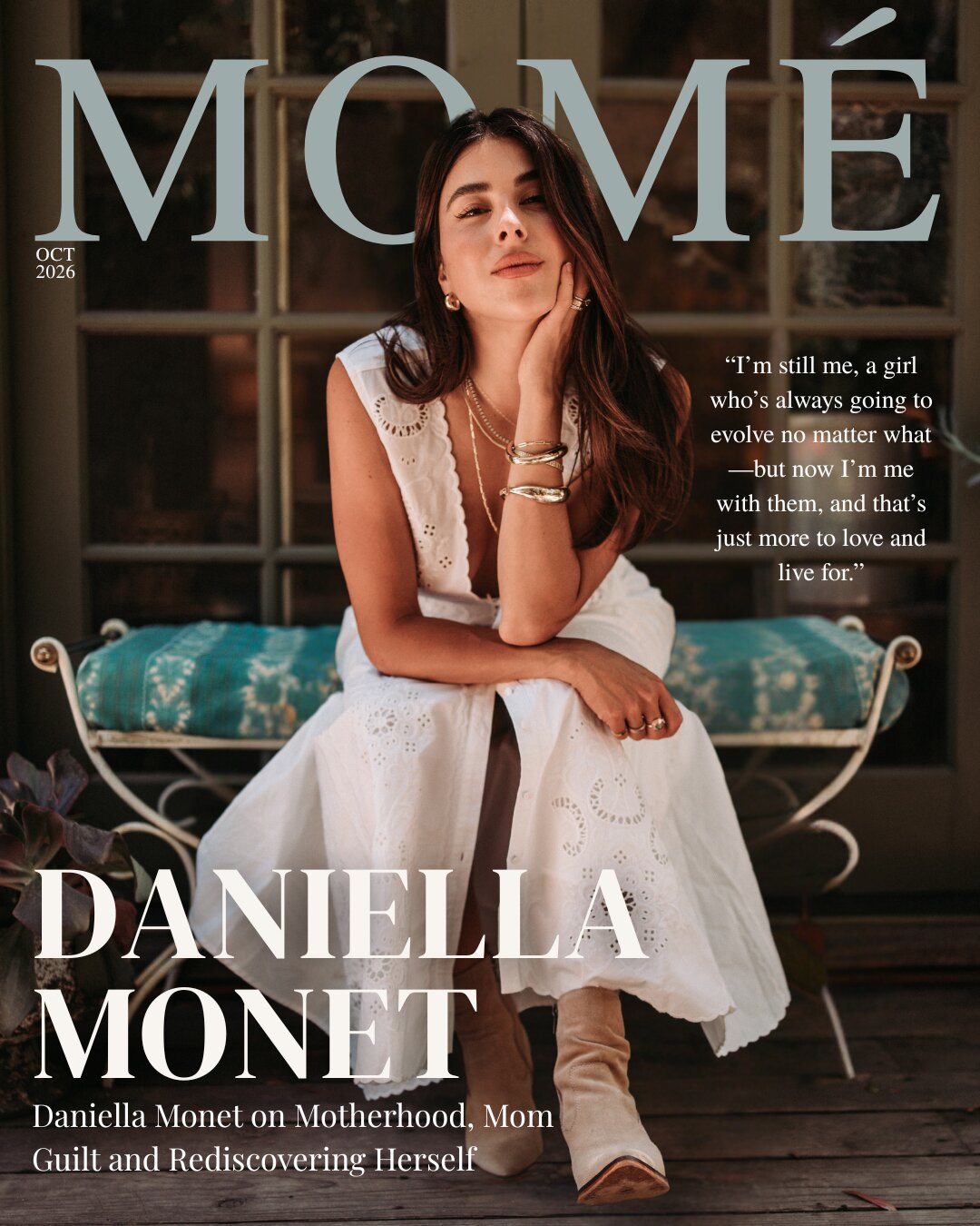 Momé October 2026 cover &mdash; Daniella Monet, in a white eyelet dress and suede boots, sits on a wrought-iron bench in front of French doors, chin resting on her hand, beneath the cover lines &lsquo;Daniella Monet&rsquo; and &lsquo;Daniella Monet on Motherhood, Mom Guilt and Rediscovering Herself&rsquo;, with the quote &lsquo;I&rsquo;m still me, a girl who&rsquo;s always going to evolve no matter what &mdash; but now I&rsquo;m me with them, and that&rsquo;s just more to love and live for.&rsquo;