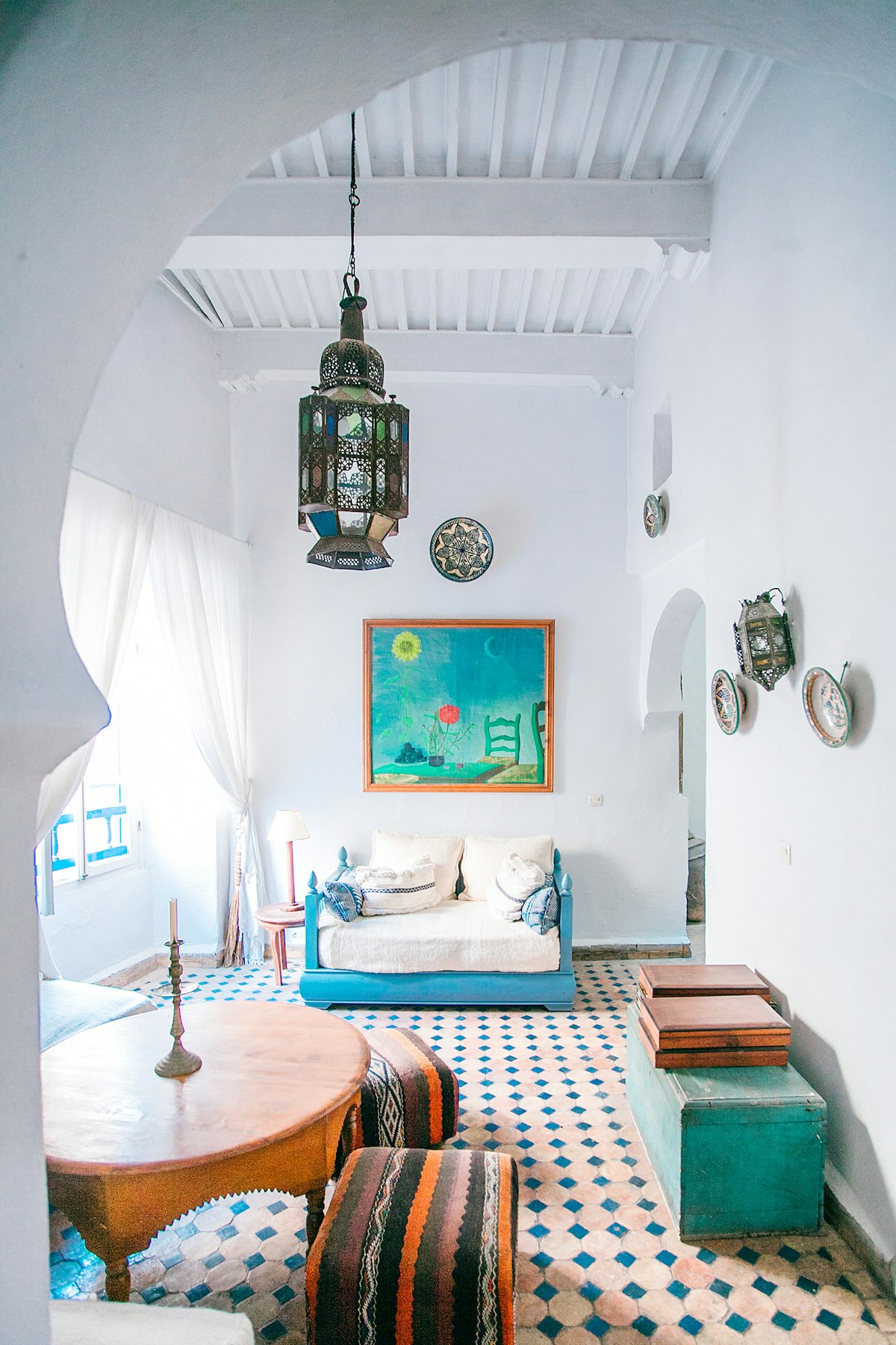 A warmly lit interior with a vintage lamp and patterned rug
