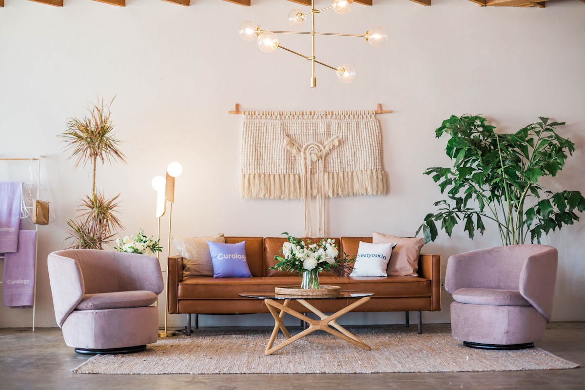 A serene mid-century living room with cream sofa, brass accents, and natural light